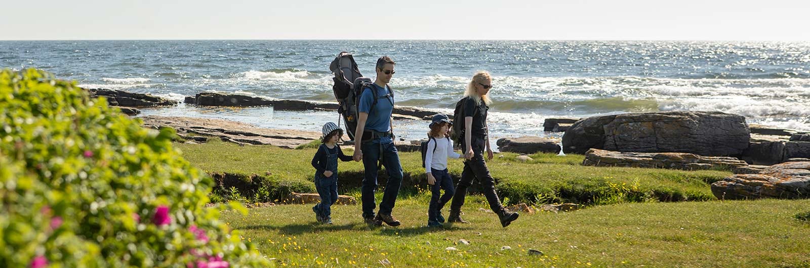 Familj vandrar vid havet i Österlen