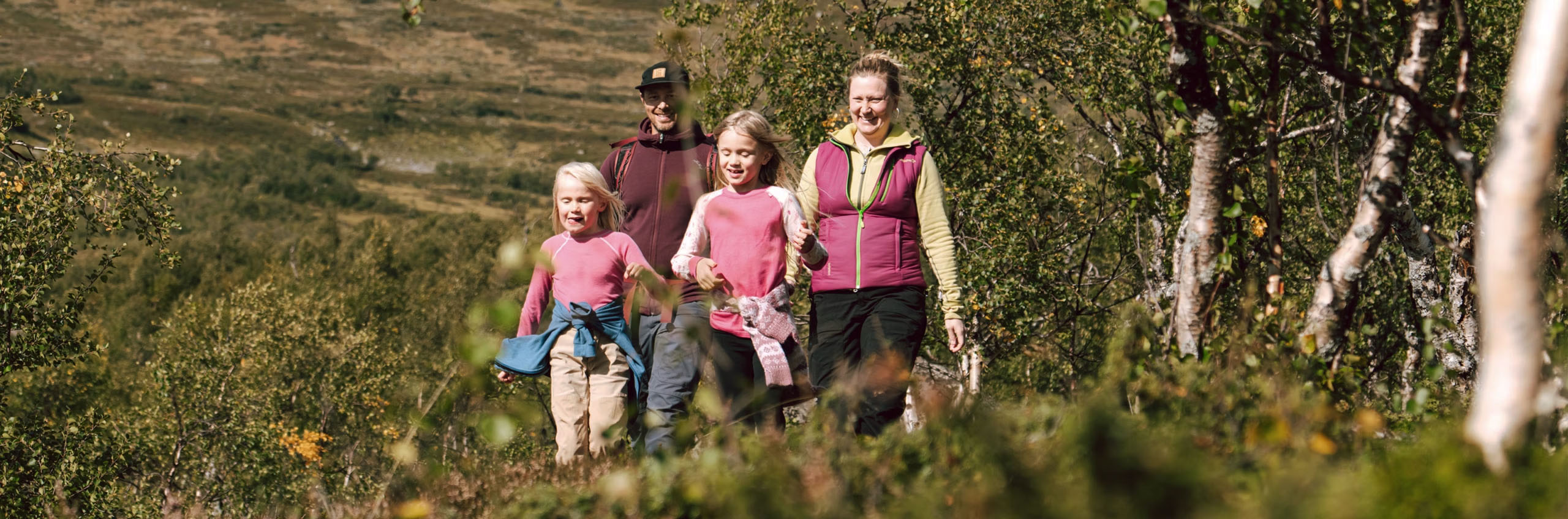 Barnfamilj vandrar i fjällen.