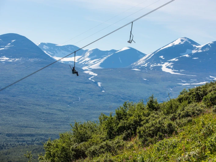 En person som åker i en skidlift i bergen.
